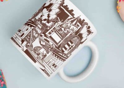 a white mug with a black and white design on it